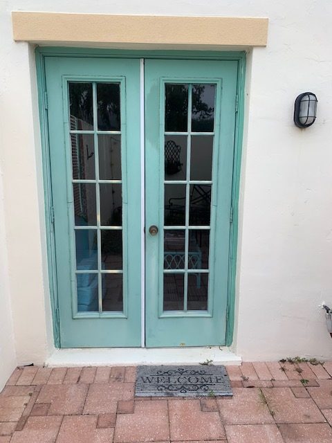 Light blue French doors installation by Anything In Doors in Cape Coral, FL.