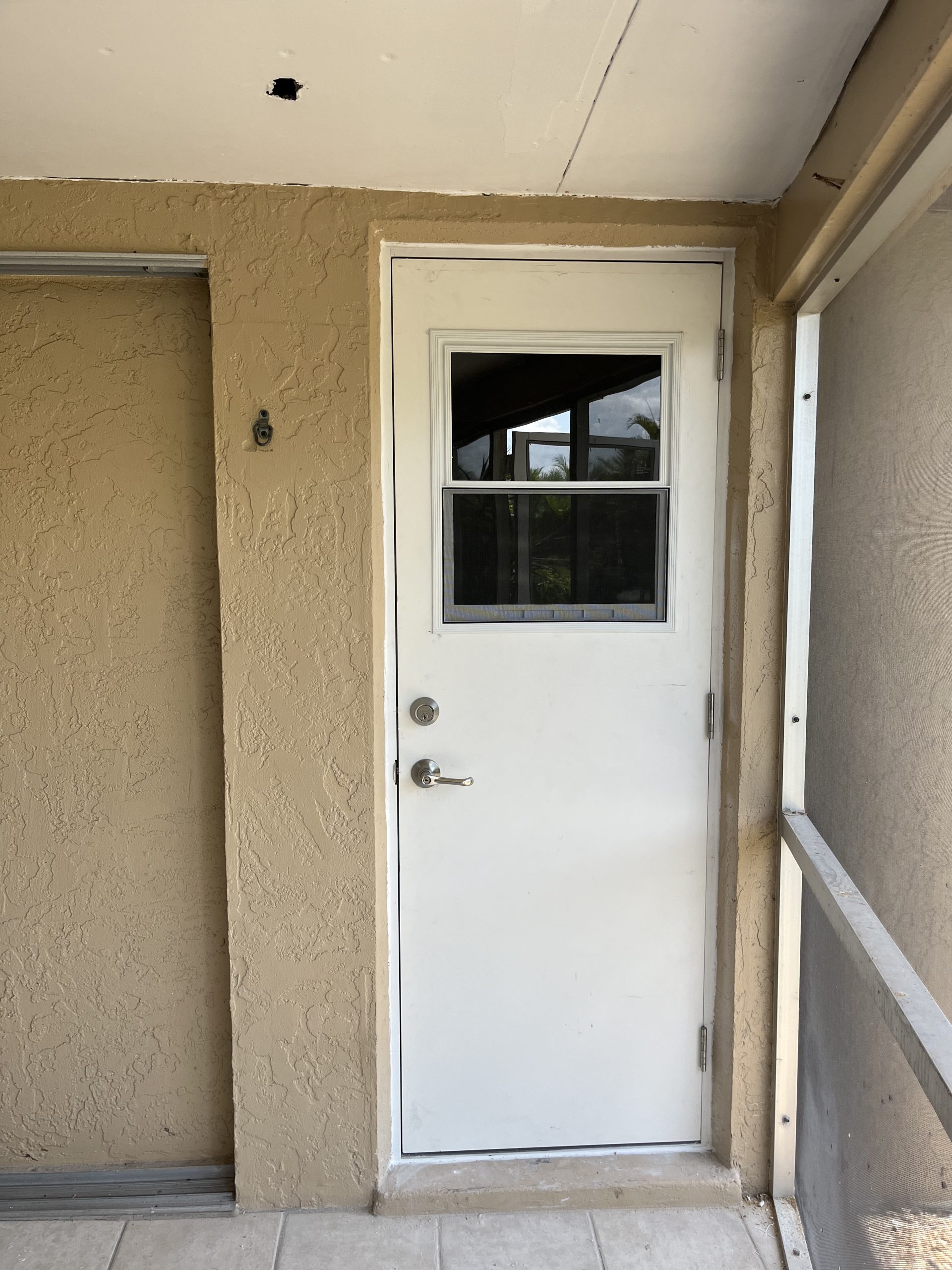 Before and after image of a newly installed white office interior door on a concrete shed, showcasing clean lines and modern design.
